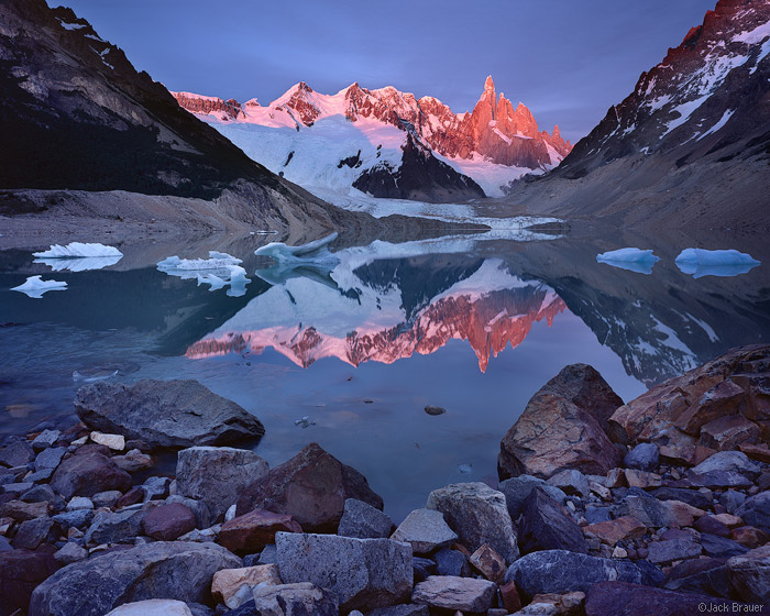 Sunrise alpenglow reflection of Cerro Torre,  10174 ft., in Lago Torre. In this perpetually windy region, calm lake reflections...